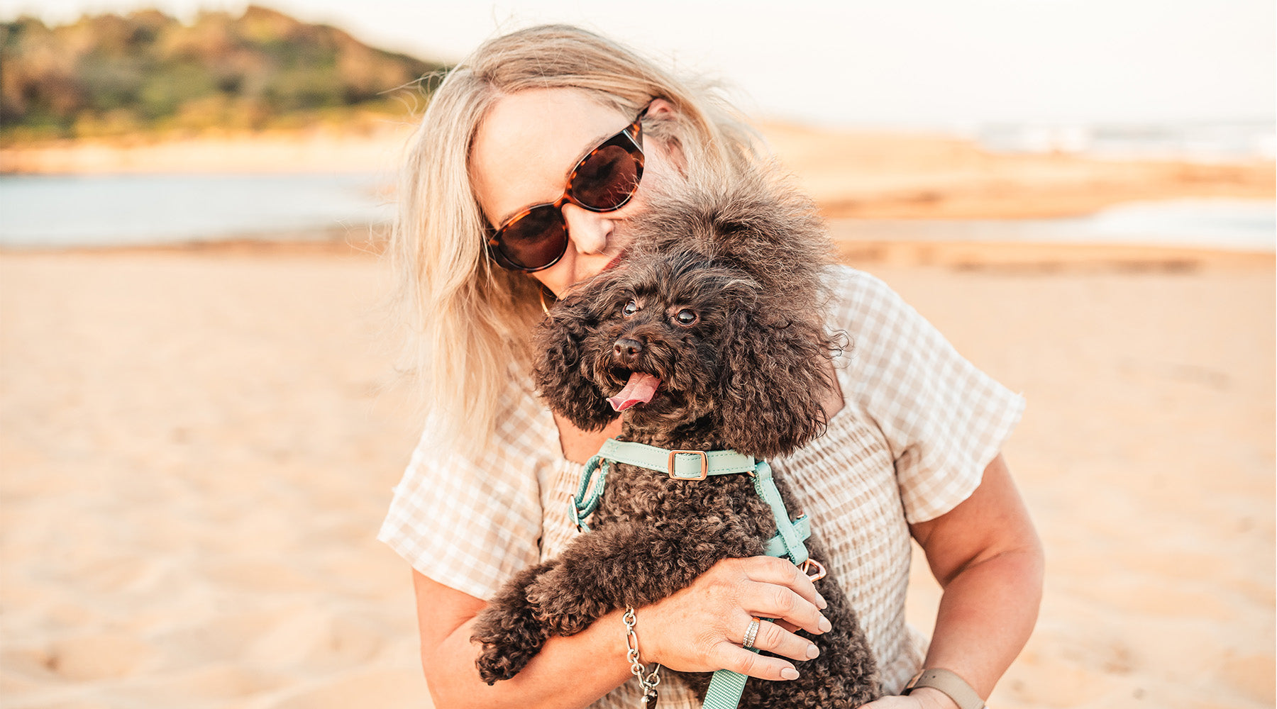 Meg from Fetching Ware holding a dog with a stylish Fetching Ware Harness